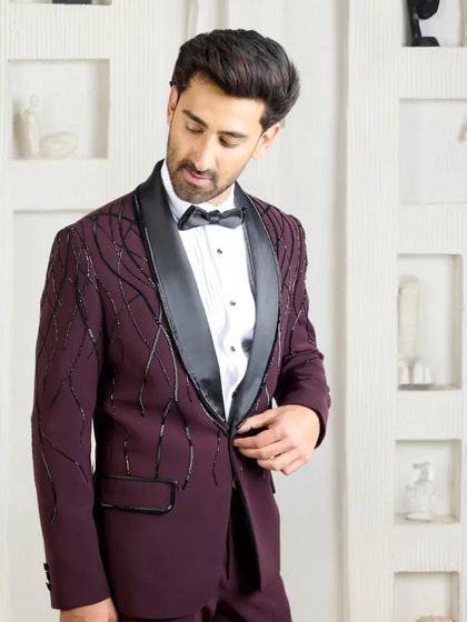 A slightly different angle of the wine-colored tuxedo, capturing the way the light hits the beadwork and the sheen of the silk lapel.