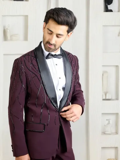 A slightly different angle of the wine-colored tuxedo, capturing the way the light hits the beadwork and the sheen of the silk lapel.