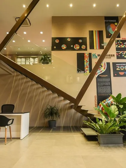 A comprehensive look at a conventional commercial space, highlighting the double-height reception, glass-walled mezzanine, and various product display areas designed for a modern business.