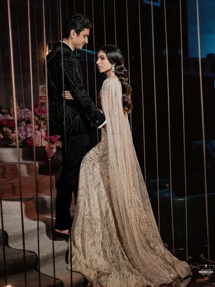 A romantic and moody portrait of the couple on a staircase, their pose and the lighting creating a very cinematic feel.