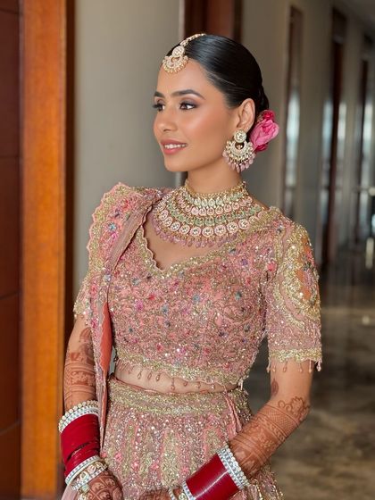 Harsheen's Anand Karaj look was breathtaking. Her intricately embroidered pastel lehenga was paired with a flawless base, soft pink eyeshadow, and a sleek bun adorned with a flower.