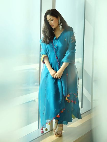 A full-length shot of Yami Gautam's ethnic attire. The simple, elegant makeup allows the beautiful details of her outfit to shine.