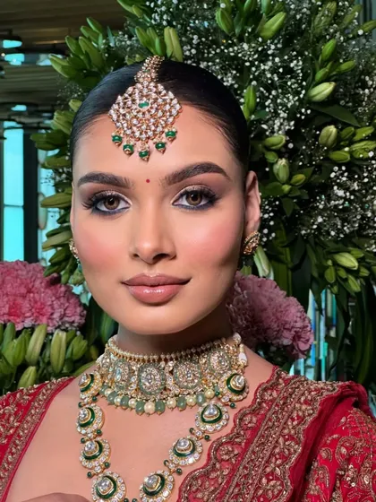 A classic bridal portrait against a floral backdrop. The red lehenga and green jewelry create a beautiful contrast that I intentionally styled.