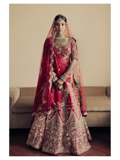 A breathtaking bridal portrait in a classic red Sabyasachi lehenga. The bride stands with poise and confidence, a picture of timeless grace. I aim to create portraits that are both powerful and elegant.