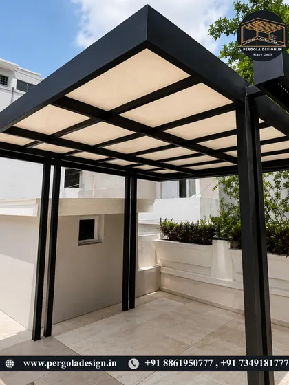 A close-up perspective of the modern black pergola, showing the robust corner joints and the clean finish of the powder-coated steel. The design is both structurally sound and aesthetically pleasing.