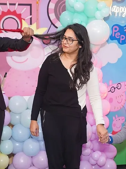 Our entertainment options keep guests of all ages captivated. Here, a professional magician performs an amazing trick, delighting both children and adults during a Peppa Pig themed birthday party.