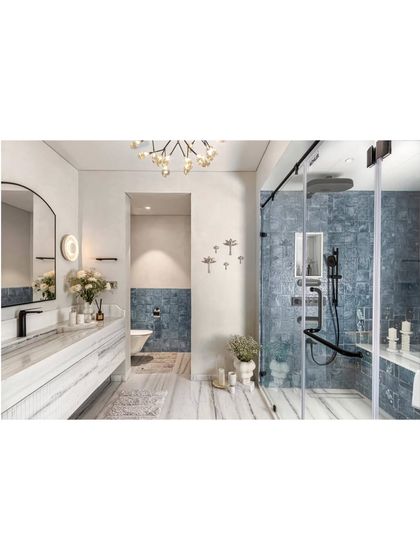 The master bathroom, a sanctuary of white marble and deep blue tiles, was featured for its balance of luxury and restraint. It's a space that feels both opulent and modern, a testament to our design philosophy.