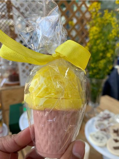 A bright and zesty lemon ice cream cone soap, individually wrapped and tied with a yellow ribbon. It's like sunshine in soap form.