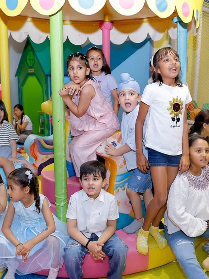 The kids are all captivated by the magic show during a unicorn-themed birthday celebration.