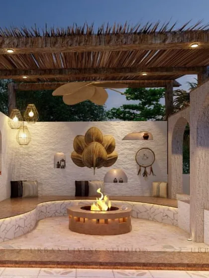 A beautiful fusion of modern and vintage styles. This design for a Pitampura terrace features a sunken fire pit with curved seating and a rustic thatched-roof pergola.
