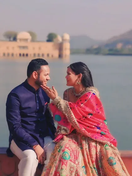 We love destination pre-wedding shoots. Here, we captured a tender moment with the stunning backdrop of Jal Mahal in Jaipur, blending royal architecture with the couple's romance.