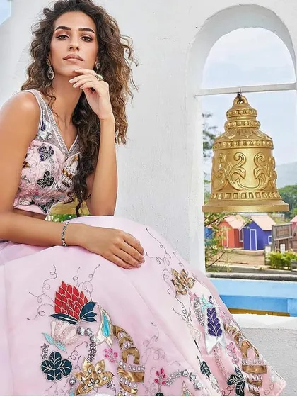 A commercial shot for a festive wear collection. The makeup is elegant and defined, with an emphasis on flawless skin and eyes that sparkle, fitting the celebratory theme.