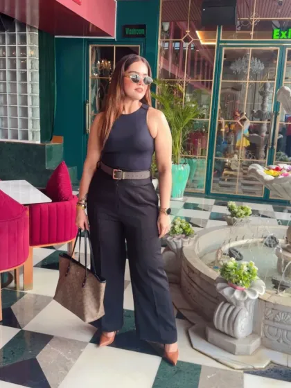 This is what I call power dressing. A sharp, all-black ensemble with a defined silhouette that's perfect for making a strong impression. This look combines a classic Zara top with Michael Kors and Coach accessories for effortless authority.