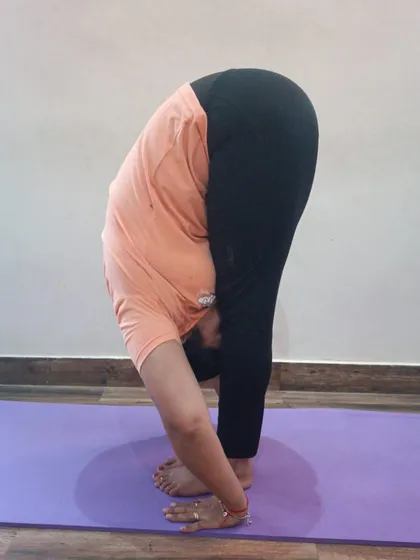 A demonstration of Padahastasana (Hand Under Foot Pose). This deep forward bend helps to calm the brain and relieve stress and mild depression.