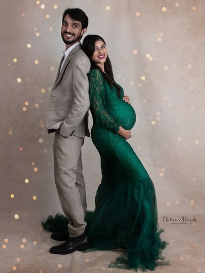 A classic back-to-back pose that is both elegant and strong. The couple looks confident and happy together.