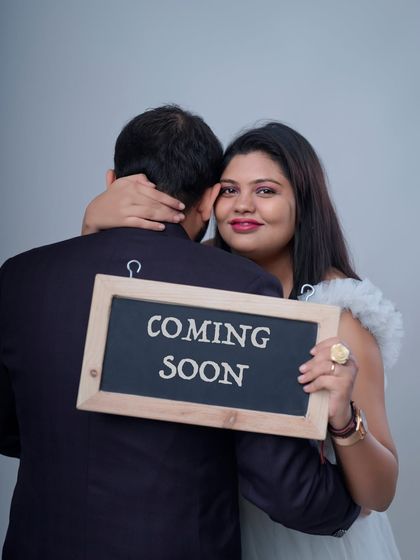 The adventure is just about to begin. This playful "Coming Soon" announcement shot captures the couple's excitement and love as they embrace the journey ahead.