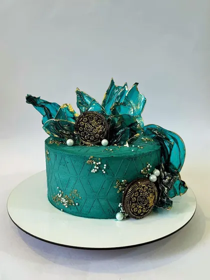 A different angle of the jade green cake, highlighting the intricate geometric pattern and the delicate placement of the edible pearl sprinkles.