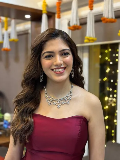 The client looks radiant and happy in her strapless gown, with soft waves adding a touch of romance to her after-party ensemble.