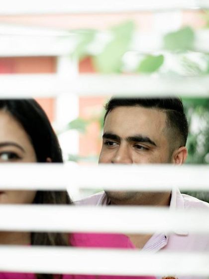 I love using elements in the environment to frame my subjects. Peeking through this white lattice adds a layer of interest and intimacy to this playful shot of the couple.