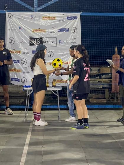 An official presents the winning ball to our team captain during the award ceremony of the Decathlon 4v4 tournament.