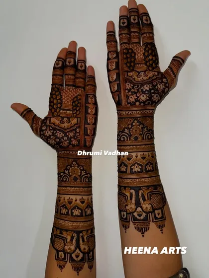 Another angle of the stunning mehendi for the groom's sister, showcasing detailed work with peacocks and traditional Indian architecture motifs.