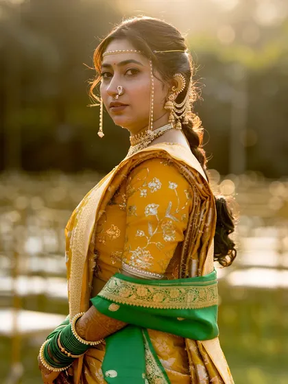 A classic back shot, highlighting the traditional hairstyle and the fall of the saree.
