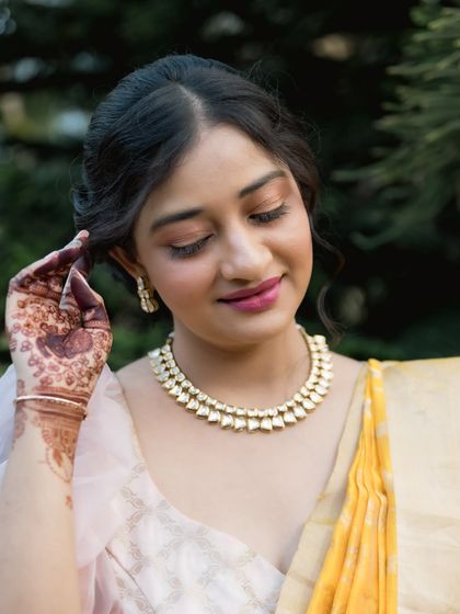 A beautiful close-up portrait of the bride. Her soft makeup and elegant jewelry perfectly complement her modern ethnic attire.