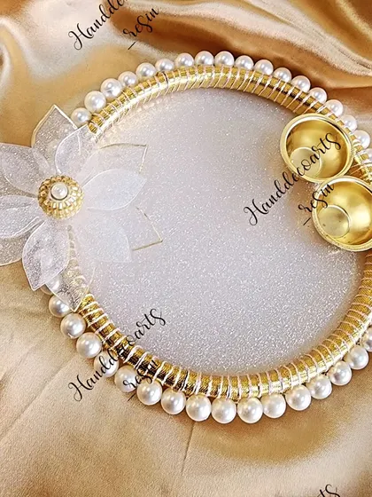 A beautiful pearl and glitter puja thali, perfect for adding a touch of elegance to your festive rituals.