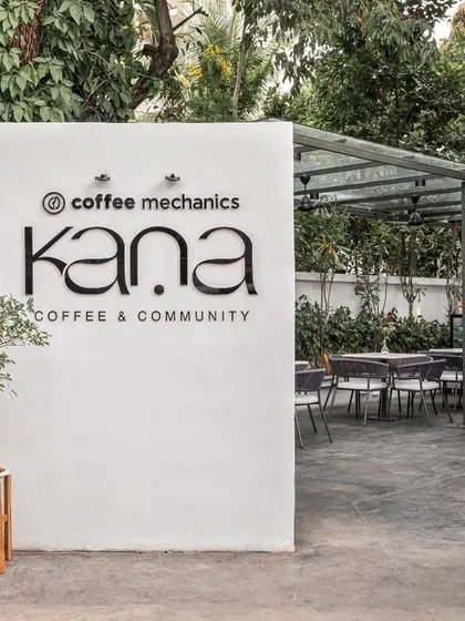The entrance to Kana Cafe, a community space I designed to be an urban retreat inspired by the breezy, nature-integrated cafes of Bali. The design focuses on creating a tranquil atmosphere with a clean, minimal aesthetic and lush greenery.