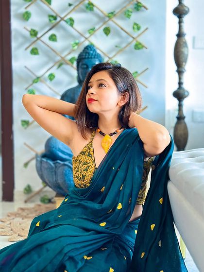This look is feminine, ravishing, and elegant. I paired this unique teal green Khadi saree with a yellow printed halter blouse, creating a stunning color combination that's perfect for a brunch or day event.