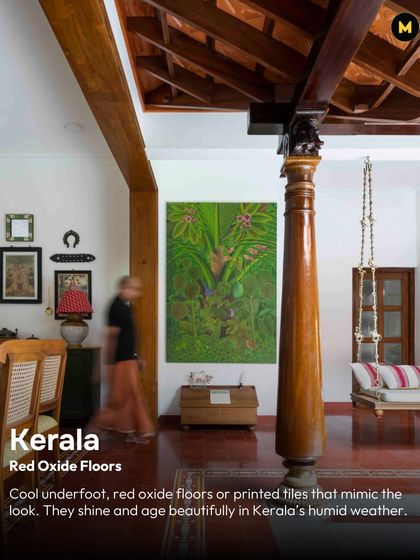 In Kerala, red oxide floors are a staple for a reason. They stay cool underfoot, age beautifully in the humid weather, and provide a rich, earthy foundation for the entire home, as seen in this space with its traditional wooden pillar and swing.