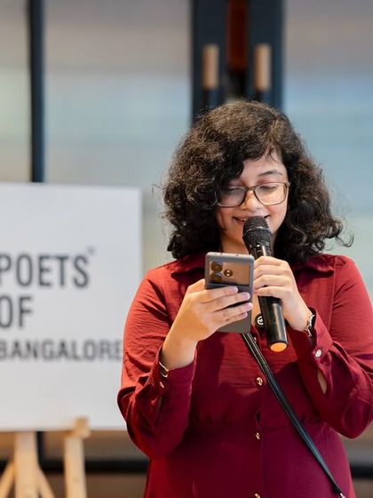 A poet reads a heartfelt piece, likely dedicated to her mother. The event was filled with emotional and touching performances.