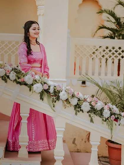 A serene portrait of the bride, Anjali, at her Mehendi. I captured her standing by a beautifully decorated staircase, her smile as bright as the floral arrangements.