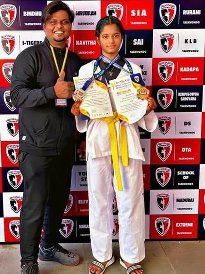 We are incredibly proud of our students' achievements. This young champion from Team NMFA showcases her hard-earned medals from a national Taekwondo competition, representing the dedication we foster.