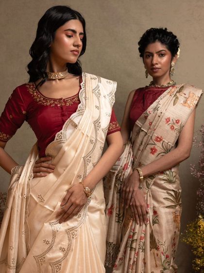 Two models showcasing our Tussar silk collection, one with delicate scallop border embroidery and the other with a traditional Pichwai print.