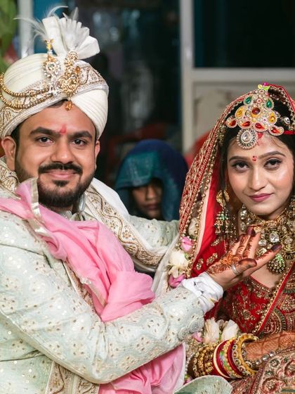 A candid moment between the bride and groom during the wedding rituals, showcasing their smiles and shared happiness.