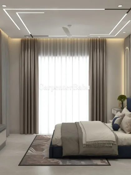 A master bedroom with a deep blue bed and a headboard wall featuring abstract art. The false ceiling has a unique linear lighting pattern, adding a modern, graphic element.