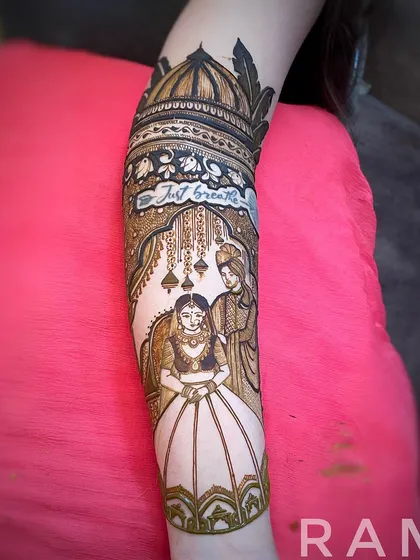 A detailed couple portrait on the forearm, framed by a beautiful archway. This design also incorporates a personal touch with the phrase 'Just breathe' hidden in the artwork.