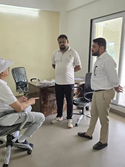 In discussion with my coaching staff during the trials, strategizing on how to best assess the talent on display.