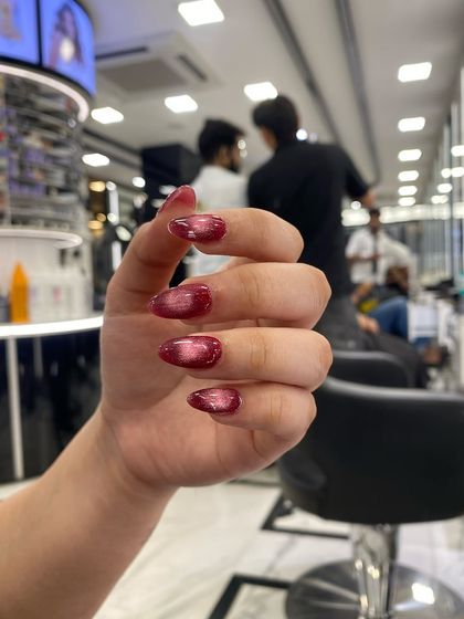 A vibrant red cat-eye effect, showing how the magnetic polish creates a beautiful line of light that moves with the nail.