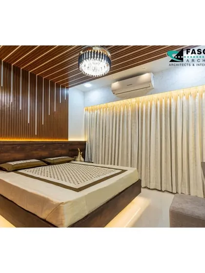 This master bedroom features a dramatic back wall with vertical wood slats and integrated LED lights. The slatted wood ceiling panel and crystal chandelier add layers of texture and luxury.