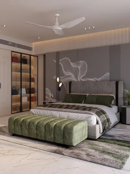 A side view of the bedroom, showing the plush green bench at the foot of the bed and the custom wardrobe with a glass-fronted section for displaying handbags.