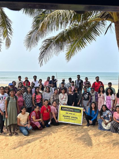 A large group photo on the sandy shores of Gokarna beach.