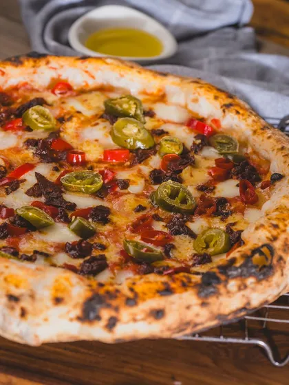This pizza is loaded with spicy jalapeños and savoury meat, perfect for those who like it hot.