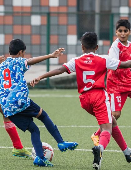 A tense moment in the midfield as players from both teams challenge for the ball. Our training prepares players for the high-pressure moments of a real match.
