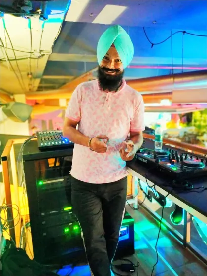 A smile behind the console. It's not just about playing songs; it's about handling the vibe and connecting with the crowd. I bring my professional Traktor and Pioneer gear to ensure flawless sound for your event.