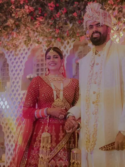 The happy couple, hand in hand, after their Varmala ceremony. Their smiles say it all.