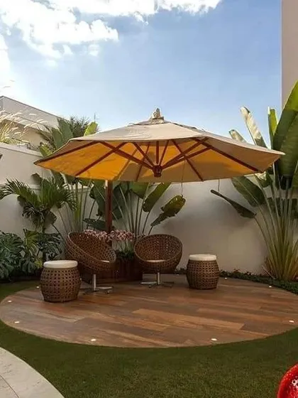 I created a dedicated relaxation zone in this large backyard using a circular wooden deck. Complemented by an oversized umbrella and comfortable wicker seating, it feels like a private island resort right at home.
