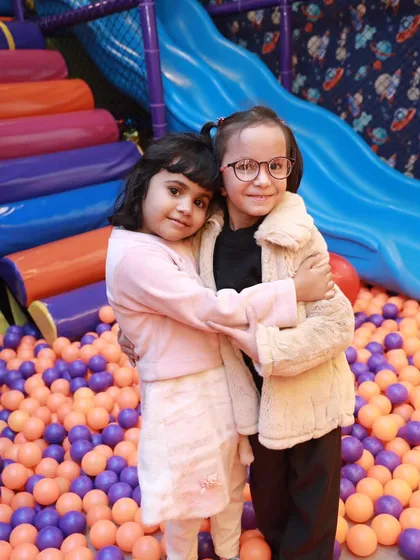 Best friends enjoying a hug in the play zone. My goal is to create a happy and friendly environment where children can bond and play.