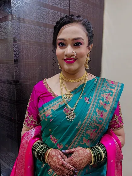 My beautiful client ready for an event in a teal and pink saree. Her makeup is fresh and glowing.